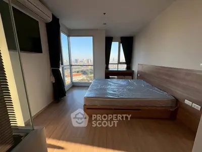 Modern bedroom with city view and large windows in high-rise apartment