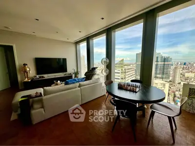 Luxurious living room with panoramic city view, modern furniture, and elegant decor in high-rise apartment.