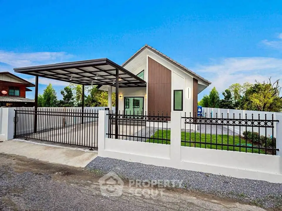 Modern single-story house with sleek design and spacious driveway in a serene neighborhood.