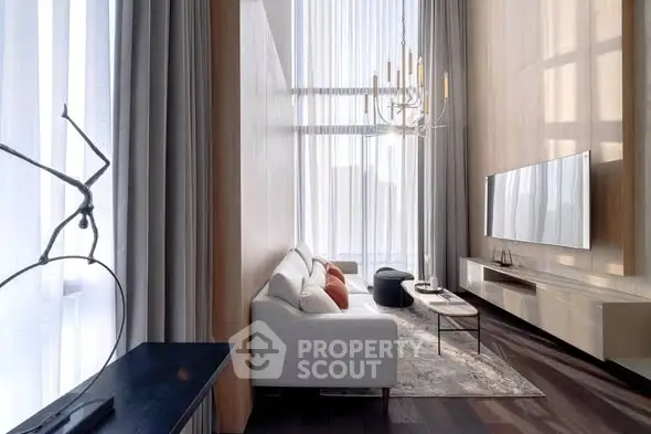 Luxurious modern living room with high ceilings, elegant chandelier, and large windows for natural light.