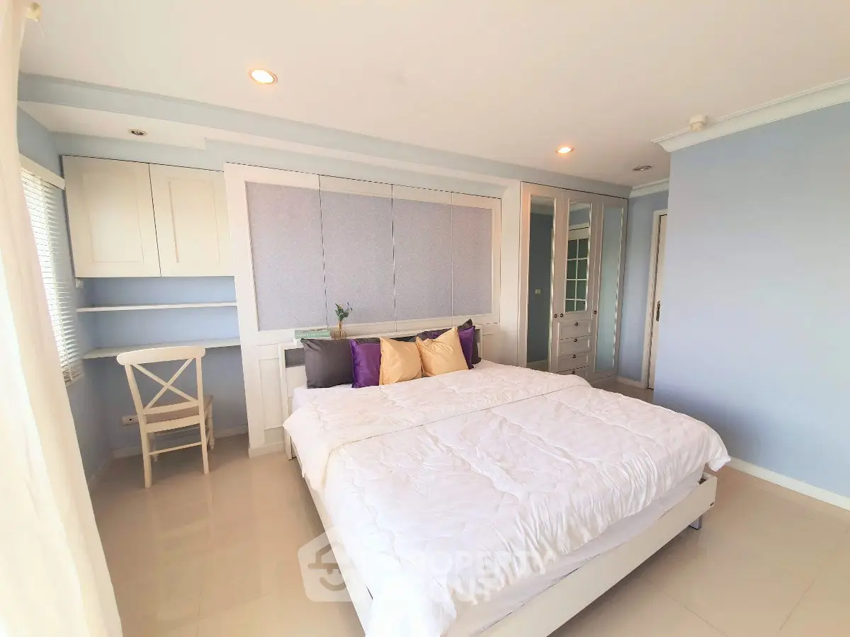 Spacious bedroom with modern decor and ample natural light