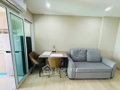 Modern living room with compact dining area and sleek furniture