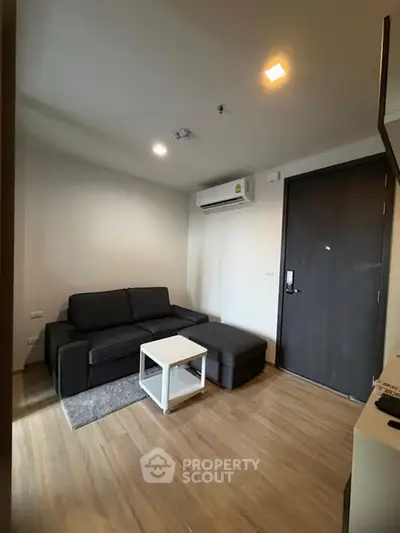 Modern living room with sleek black sofa and minimalist decor