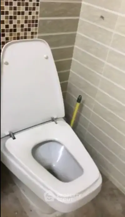 Modern bathroom with tiled walls and sleek toilet design