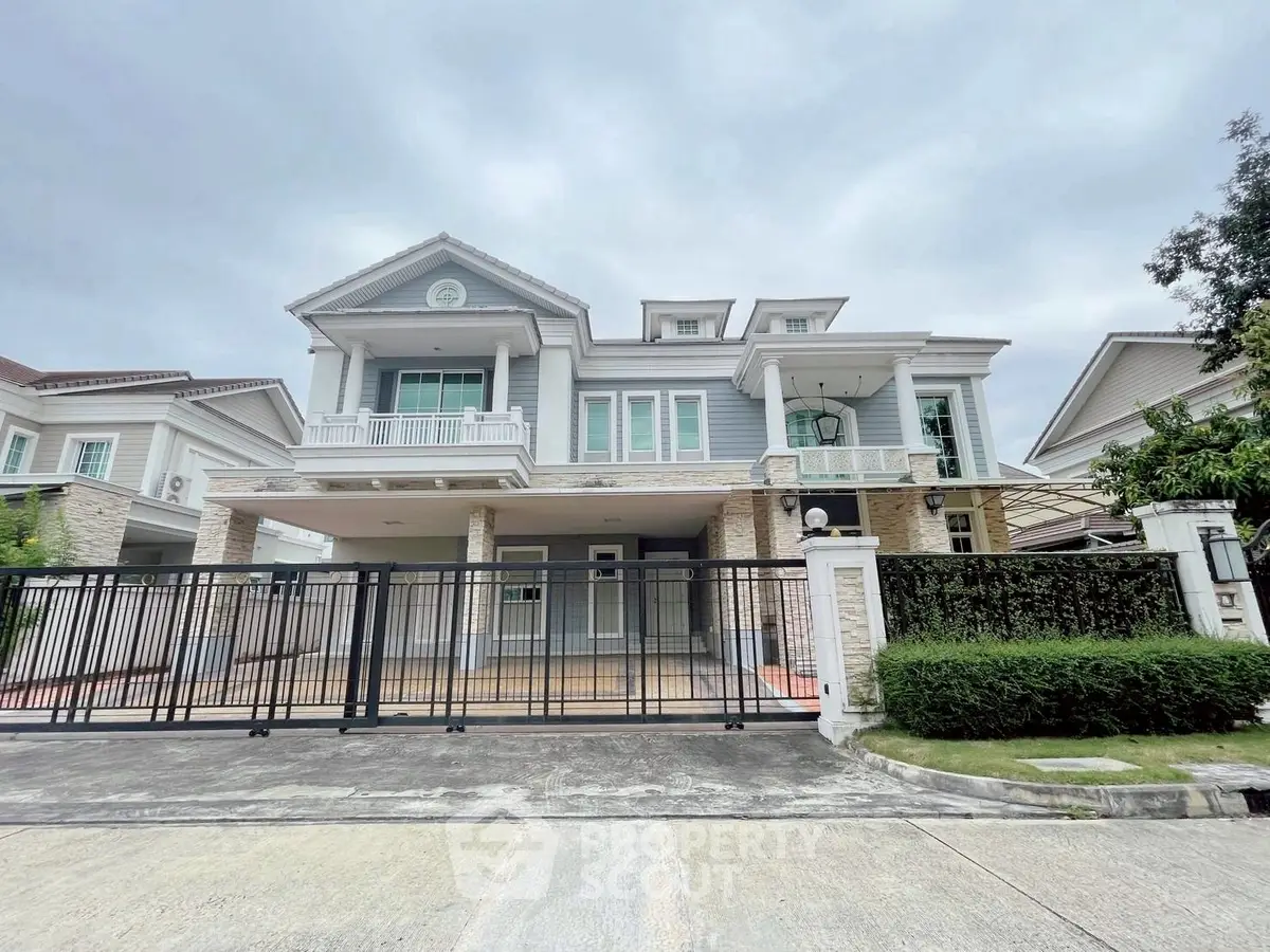 Stunning two-story house with elegant facade and spacious driveway in a serene neighborhood.
