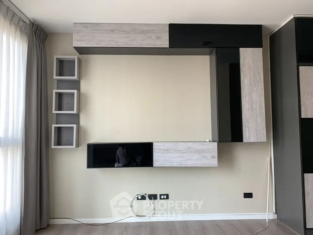 Modern living room with stylish wall-mounted storage and natural light
