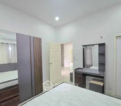 Modern bedroom with sleek furniture and ample natural light