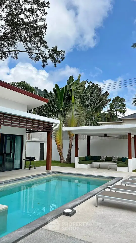 Luxurious modern villa with private pool and lush tropical garden, perfect for relaxation and entertaining.
