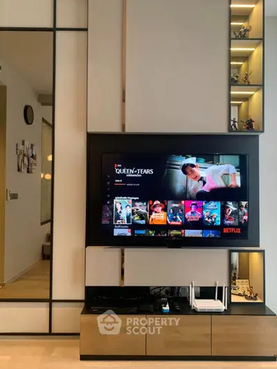 Modern living room with sleek TV setup and stylish shelving
