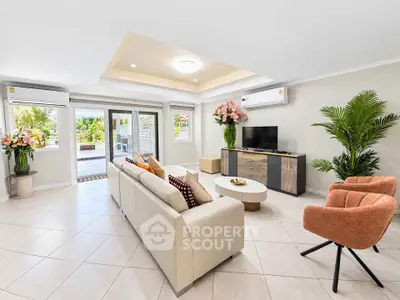 Spacious modern living room with elegant decor and garden view, perfect for family gatherings.