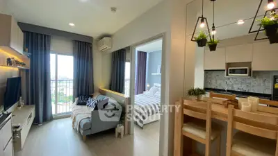 Modern open-layout apartment with stylish kitchen and cozy living area, featuring a balcony view.