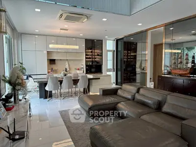 Luxurious open-plan living room with modern kitchen and sleek leather sectional sofa