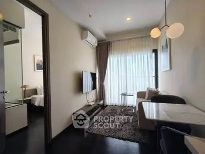 Modern living room with sleek furniture and large window for natural light