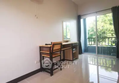 Bright study room with desk and balcony view in modern apartment