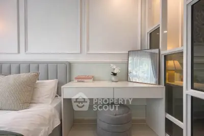 Elegant bedroom with plush bed, stylish vanity, and soft lighting for a cozy ambiance.