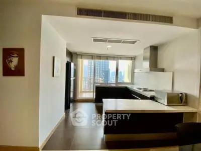 Modern kitchen with open layout and city view, featuring sleek appliances and ample natural light.