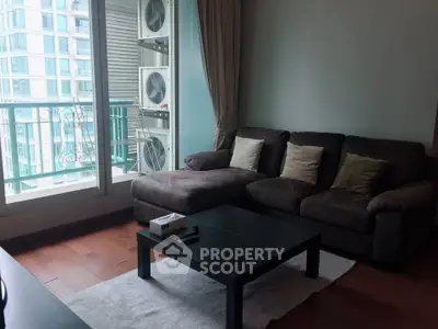 Modern living room with cozy sofa and balcony view in urban apartment