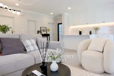 Modern living room with stylish furniture and open kitchen layout
