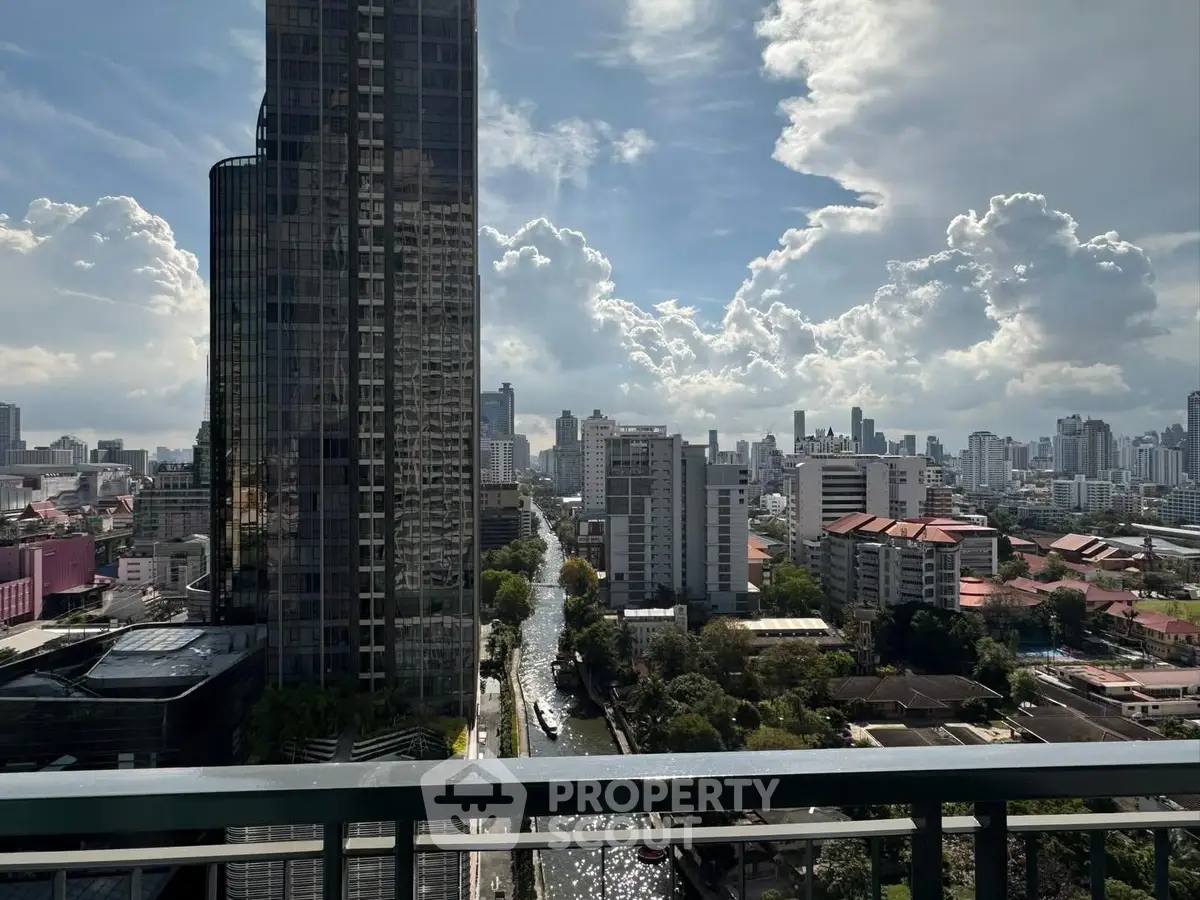 Stunning cityscape view from a high-rise balcony showcasing urban skyline and vibrant clouds.