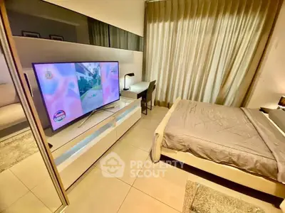 Modern bedroom with sleek design and TV, perfect for relaxation.