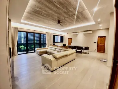 Spacious modern living room with elegant lighting and large windows