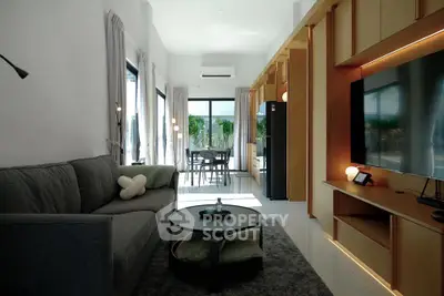 Modern living room with sleek design and large windows offering natural light