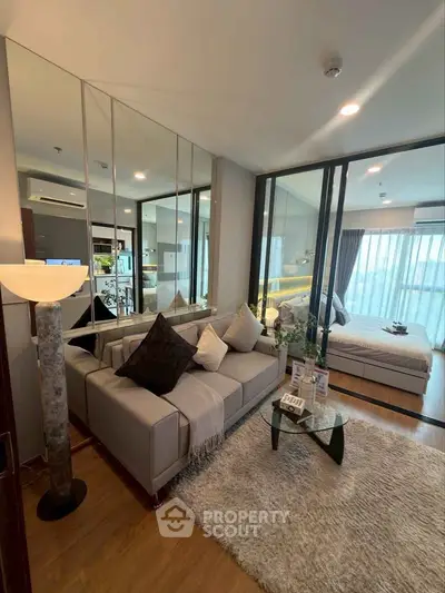 Modern living room with cozy sofa and stylish decor in open-plan apartment