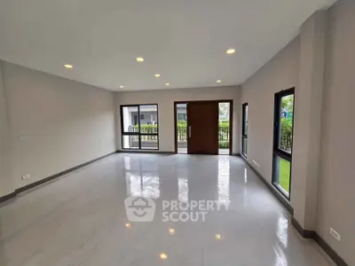 Spacious modern living room with large windows and sleek flooring