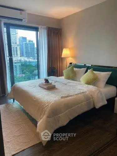 Luxurious bedroom with city view, modern decor, and cozy ambiance in high-rise apartment.