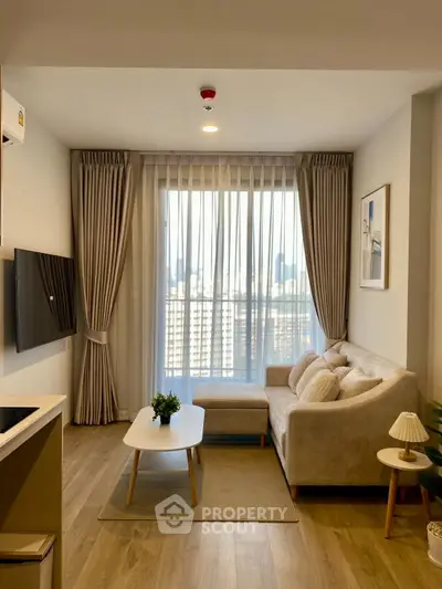 Modern living room with cozy sofa and city view through large window.