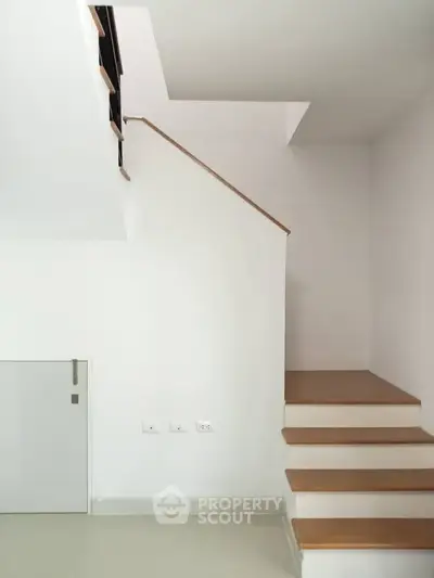 Minimalist staircase with wooden steps in modern home interior