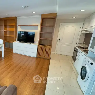 Spacious living room with modern kitchen appliances and wooden flooring