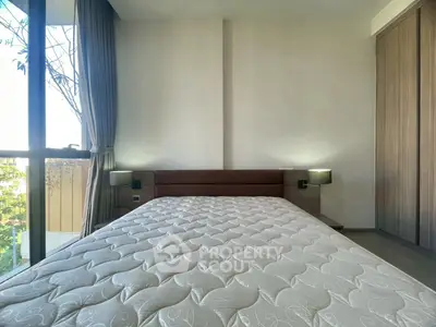 Spacious bedroom with large window and modern decor