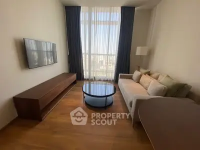 Modern living room with high ceilings, large window, and stylish furniture.