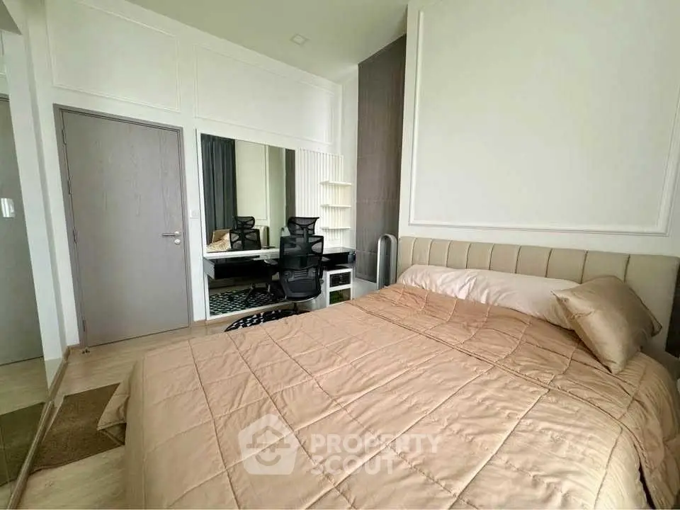 Modern bedroom with stylish decor and workspace, featuring a comfortable bed and sleek design.