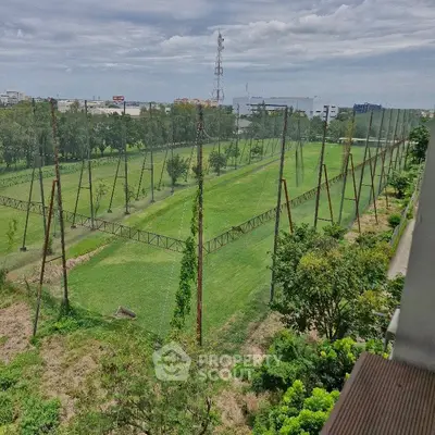 Expansive green golf course view from a high-rise balcony, perfect for nature lovers.