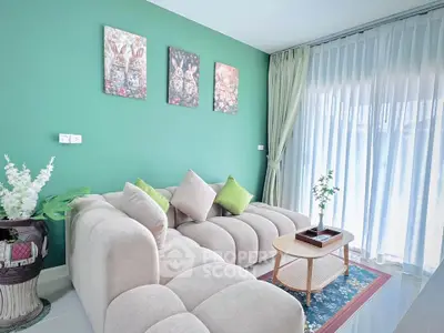Stylish living room with plush sofa and green accent wall