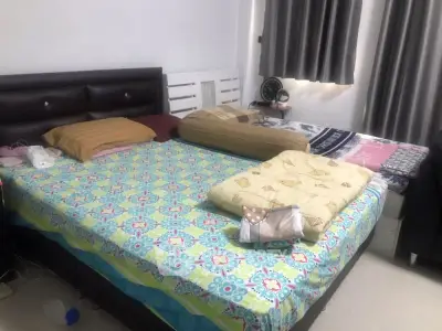 Cozy bedroom with double bed and colorful bedding, perfect for relaxation.