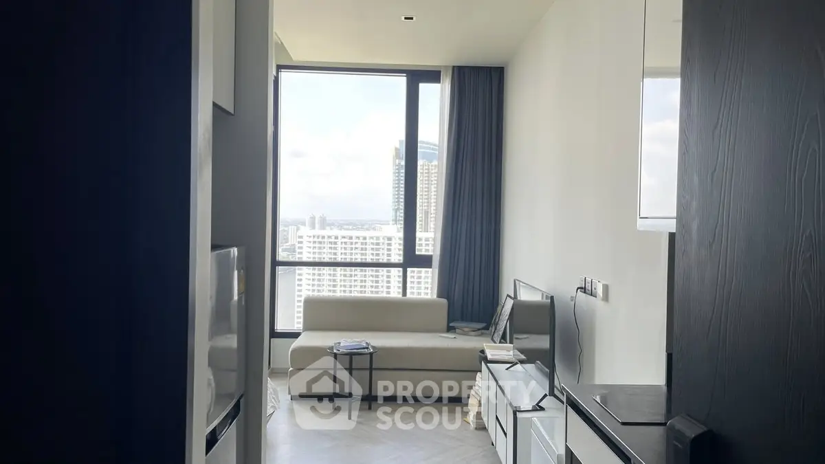 Modern living room with large window and city view