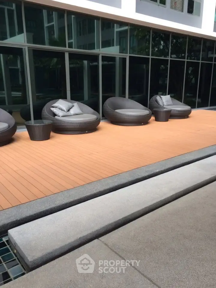 Modern outdoor seating area with stylish furniture and wooden deck