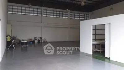 Spacious industrial warehouse with high ceilings and ample storage space.