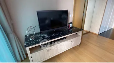 Modern living room with sleek TV stand and marble top, showcasing elegant interior design.