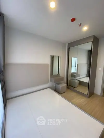 Modern bedroom with mirrored wardrobe and minimalist design