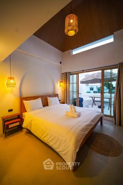 Luxurious bedroom with elegant lighting and poolside view, perfect for a serene retreat.