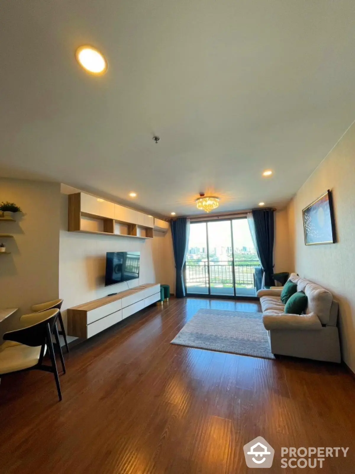 Spacious living room with modern decor and large balcony view