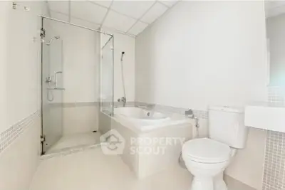 Modern bathroom with glass shower and bathtub in bright white tones