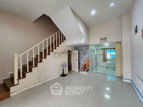 Spacious living room with staircase and modern decor in a stylish home