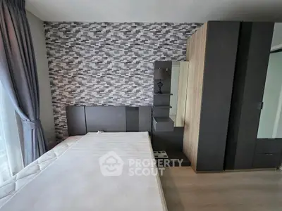 Modern bedroom with stylish geometric accent wall and sleek furniture