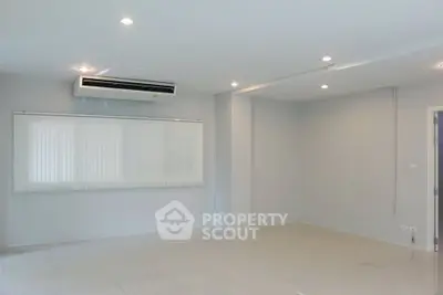 Spacious empty room with air conditioning and tiled floor, perfect for customization.