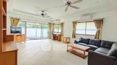 Spacious living room with modern furniture and large windows offering natural light.